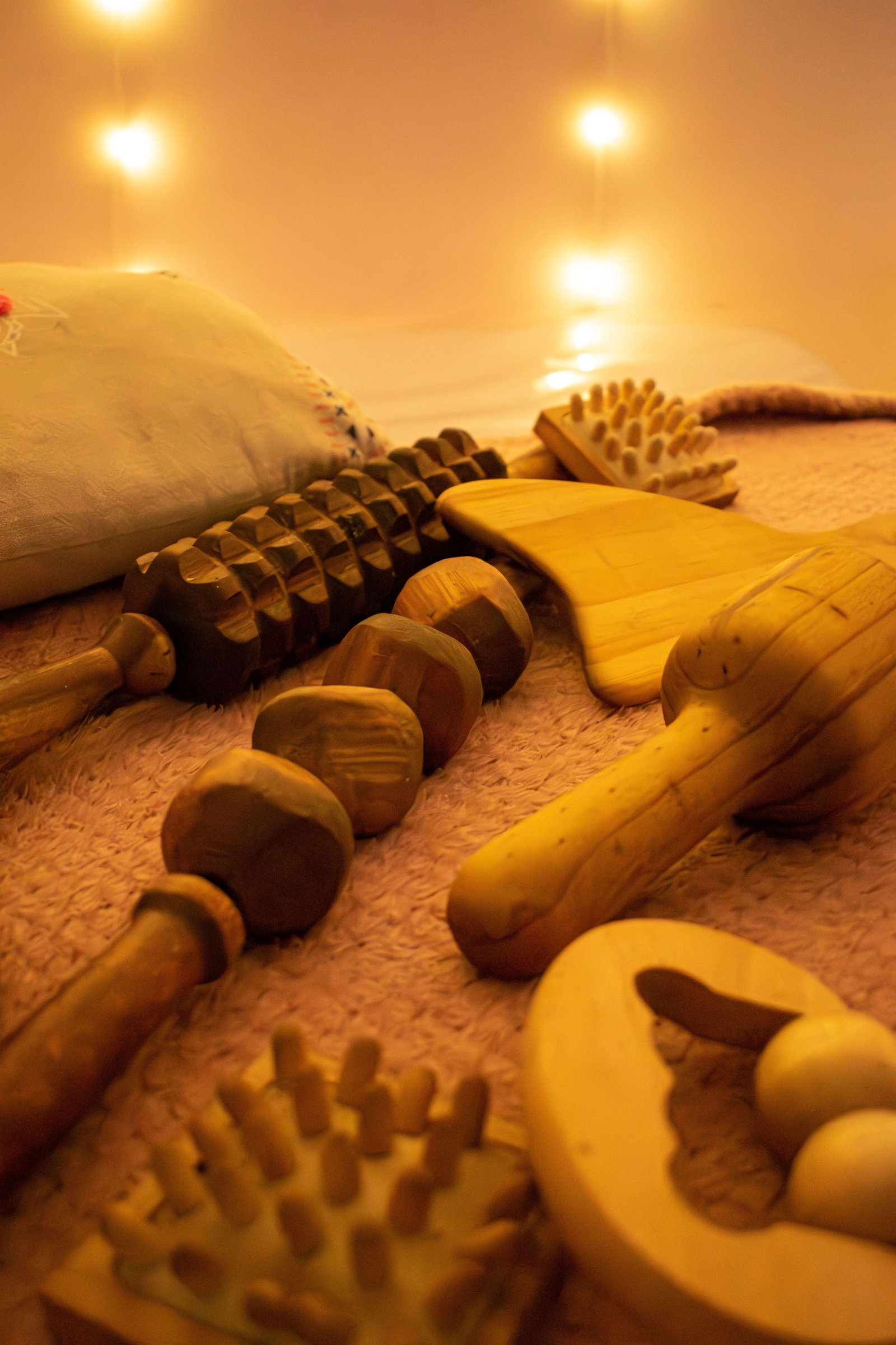 Wooden maderotherapy tools arranged on a natural surface